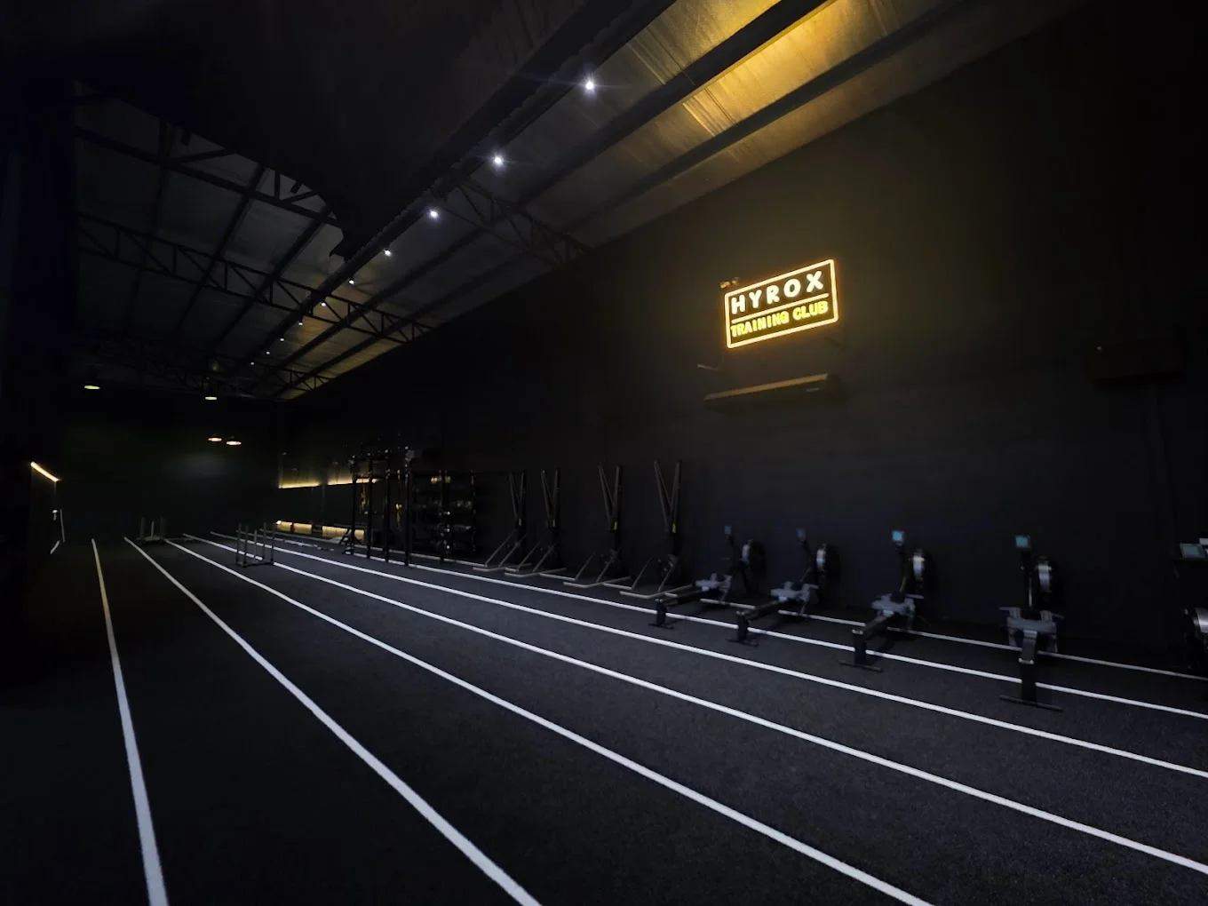 HYROX Training Club running track and rowers