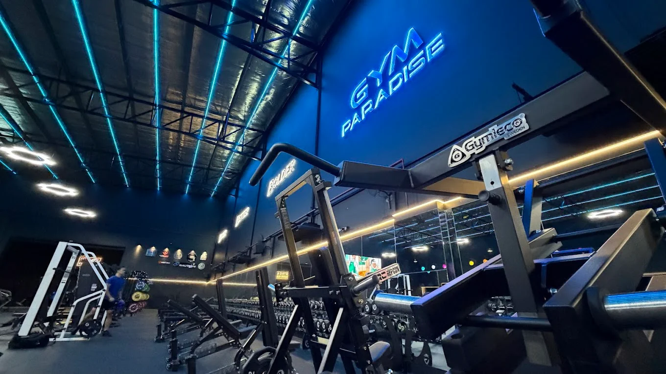 Equipment rows with GYM PARADISE neon